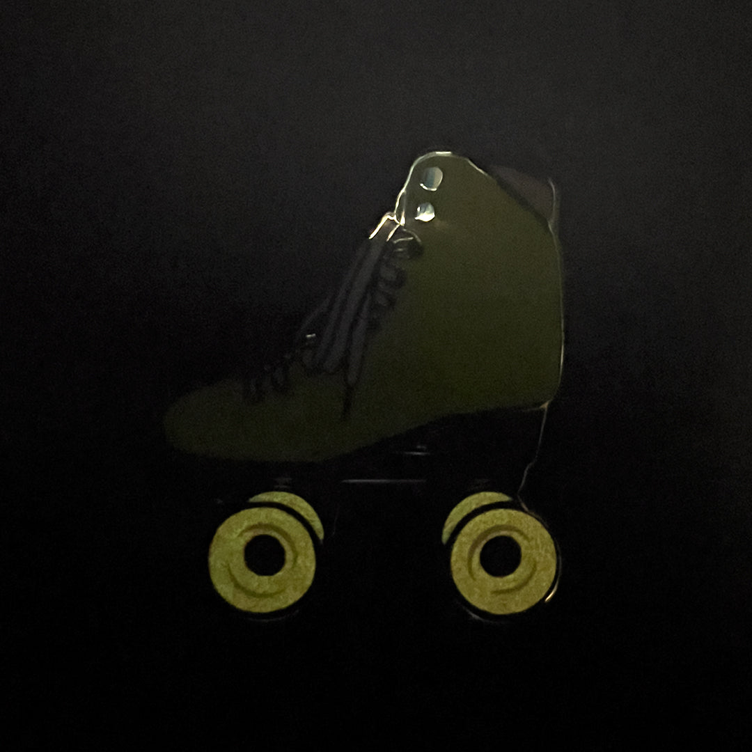 Yellow roller skate pin with glow in the dark wheels